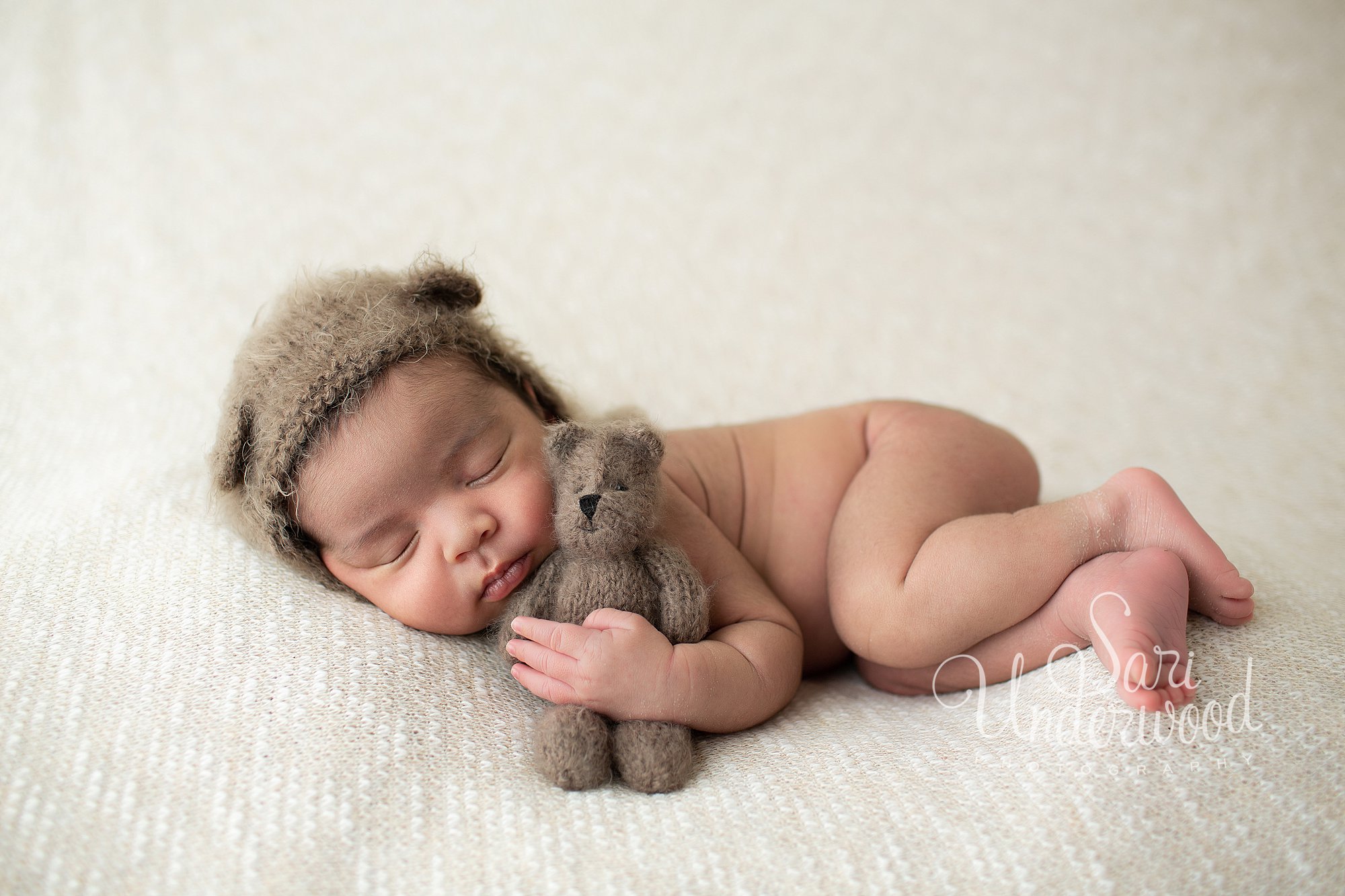 new baby boy in bear knit hat 